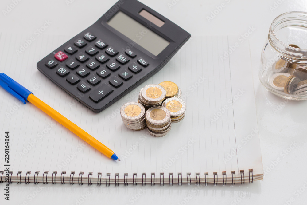 Banknotes and Calculator with Notebook, Egyptian Money, White Background Banknotes and Calculator with Notebook, Egyptian Money, White Background