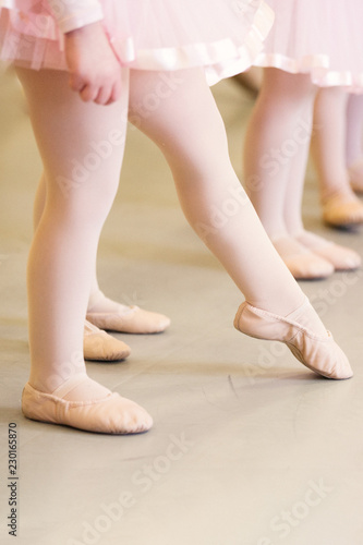 Baby ballet feet pointed in a pink skirt