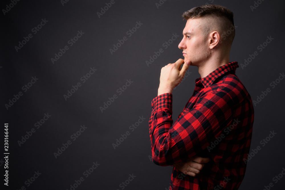 Profile view of young handsome man thinking Profile view of young handsome man thinking