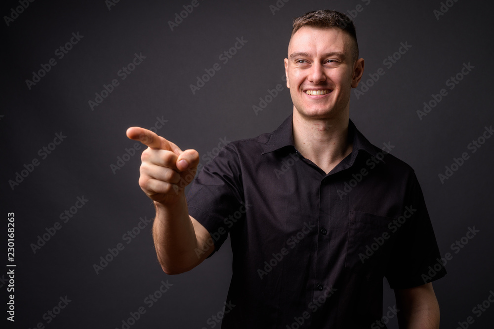 Portrait of happy businessman laughing and pointing finger Portrait of happy businessman laughing and pointing finger