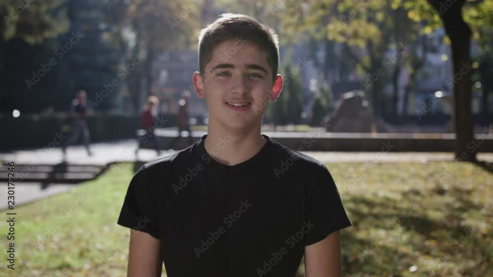 Young man smiling and looking at camera. Portrait of a happy handsome young man in a urban street. Close up Young man smiling and looking at camera. Portrait of a happy handsome young man in a urban street. Close up