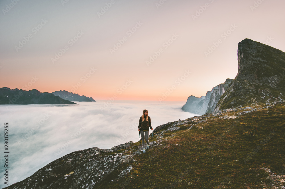 Active woman hiking in mountains outdoor active vacations traveling alone adventure healthy lifestyle girl trail running above clouds on ridge