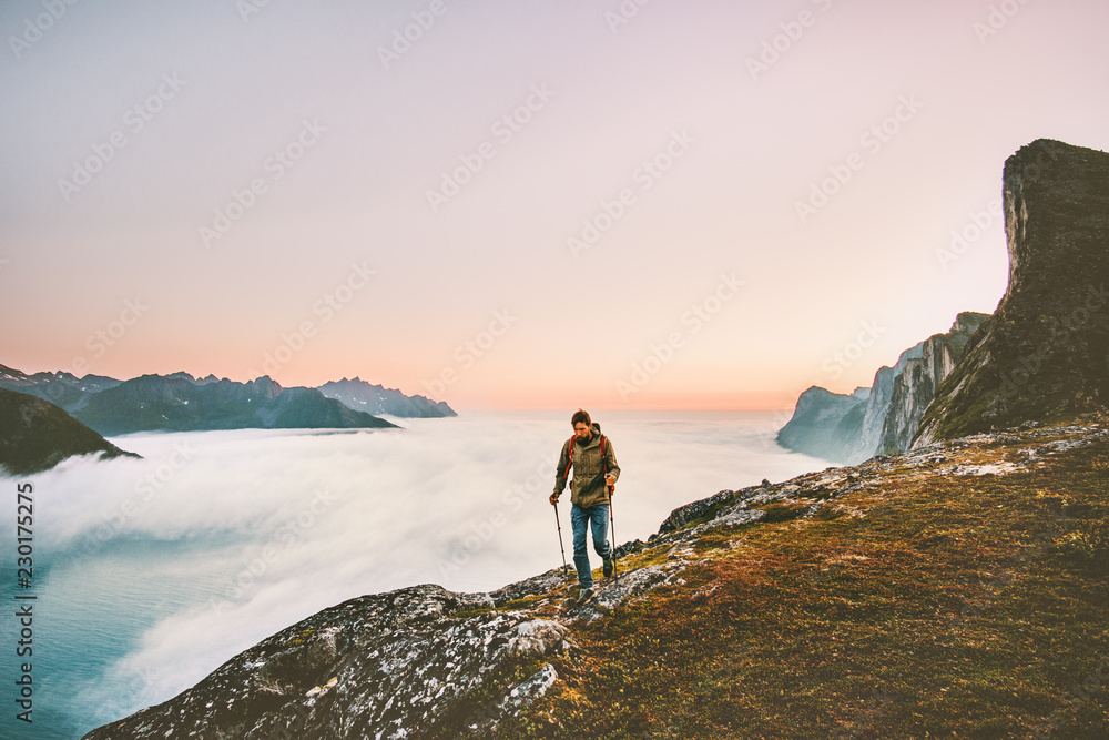 Obraz premium Active man trail running in sunset mountains with backpack Traveling heathy lifestyle adventure concept hiking alone vacations outdoor journey in Norway