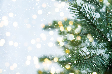 Closeup of Christmas tree with light, snow flake. Christmas and New Year holiday background. vintage color tone.