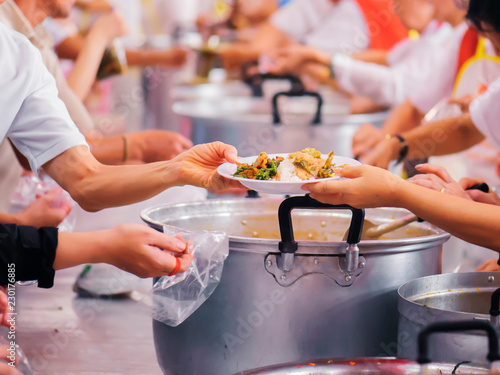 Sharing of food from volunteer hands to homeless people : The concept of feeding photo