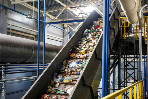 moving conveyor transporter on Modern waste recycling processing plant. Separate and sorting garbage collection. Recycling and storage of waste for further disposal. photo