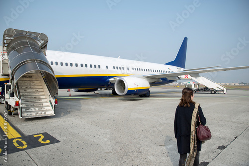 Girl ready to board on the plane and fly to a warm destination