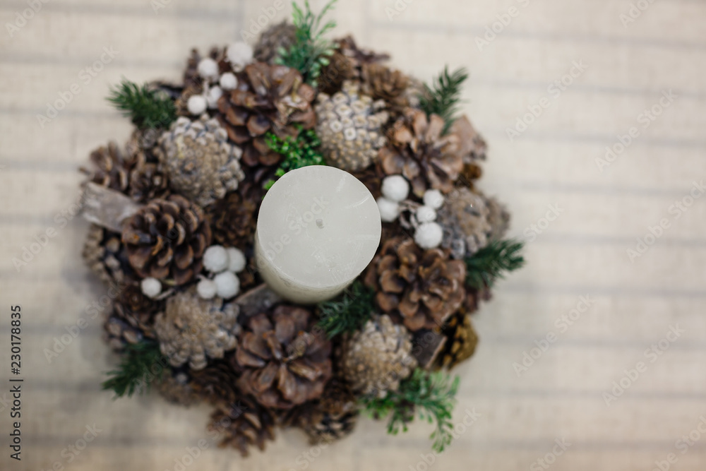 Christmas decor, advent wreath with a candle, vertical photo Christmas decor, advent wreath with a candle, vertical photo