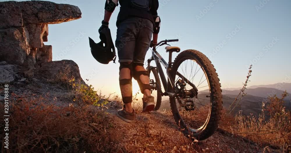 custom made wallpaper toronto digitalCool mountain cyclist standing on edge of a mountain or a hill during sunset, ready to ride down and perform stunts - recreational pursuit, getting away from it all 4k