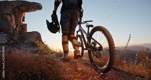 Wallpaper Mural Cool mountain cyclist standing on edge of a mountain or a hill during sunset, ready to ride down and perform stunts - recreational pursuit, getting away from it all 4k Torontodigital.ca