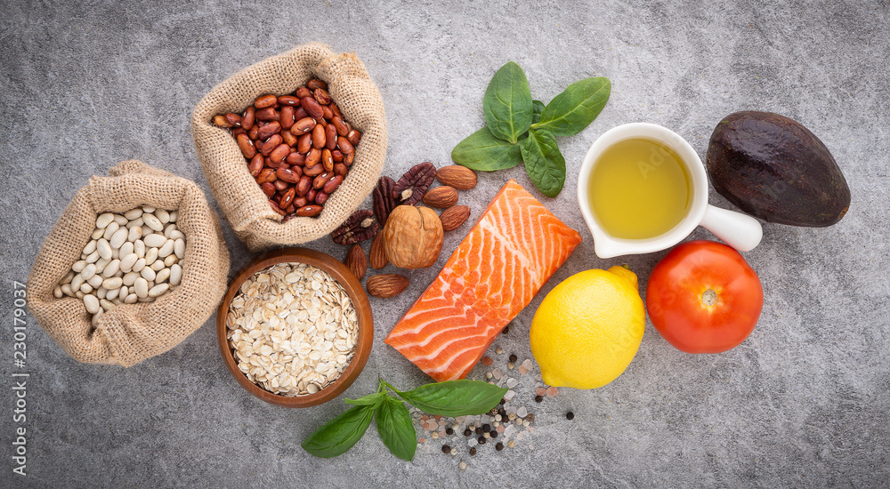 selection of healthy food. Salmon fish, nuts, salt, pepper, fruits and vegetables on stone background from top view. selection of healthy food. Salmon fish, nuts, salt, pepper, fruits and vegetables on stone background from top view.