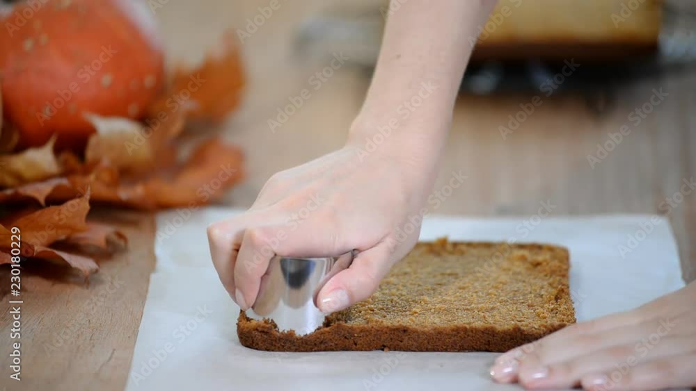 Making pumpkin mini cakes. Cutting cookies from the dough on a table. Making pumpkin mini cakes. Cutting cookies from the dough on a table.
