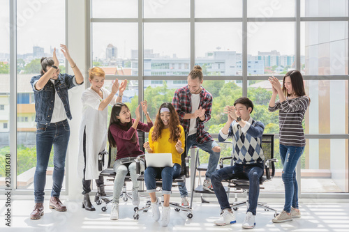 Group Of Asian and Multiethnic Business people with casual suit working with happy action and celebrate when project is completed in the modern workplace, people business group concept