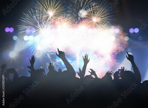 Obraz na płótnie Concert crowd in silhouettes of Music fanclub with show hand action for celebrate with fireworks, happy new year and christmas concept w salonie