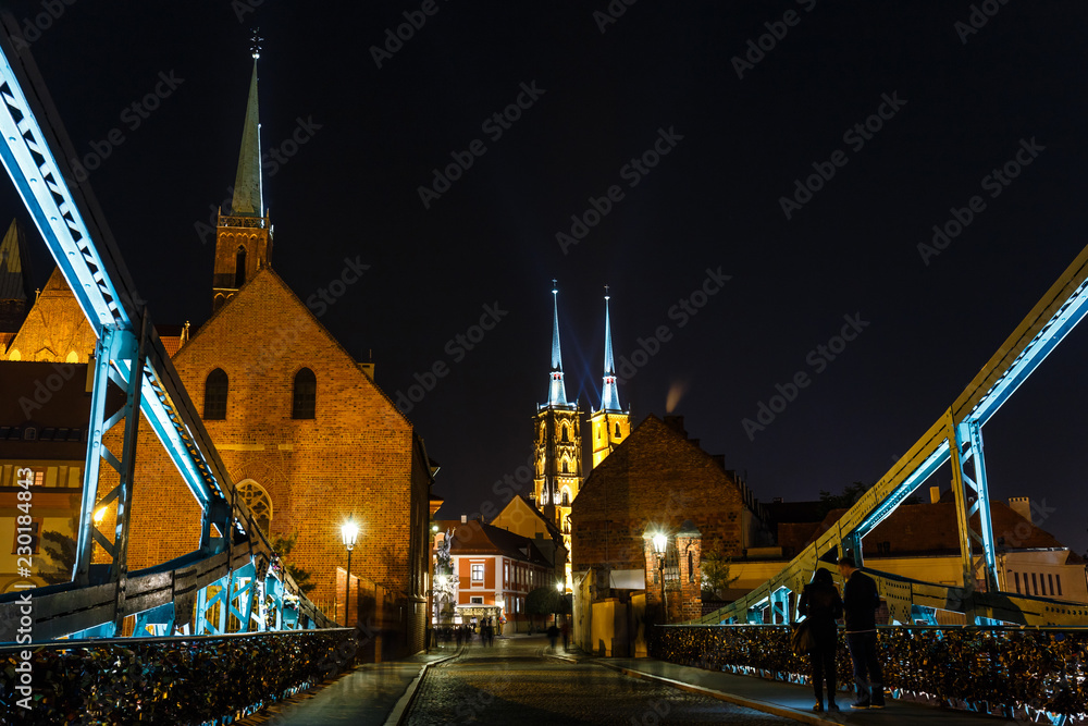 Naklejka premium Night view of church of the Holy Cross and St Bartholomew and cathedral of saint john the baptist in Wroclaw, Poland