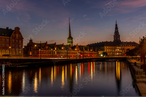 View of the Borsen (Danish for exchange) building in Copenhangen at night reflecting in the water channel - 1