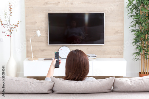 Young woman watching TV in the room photo