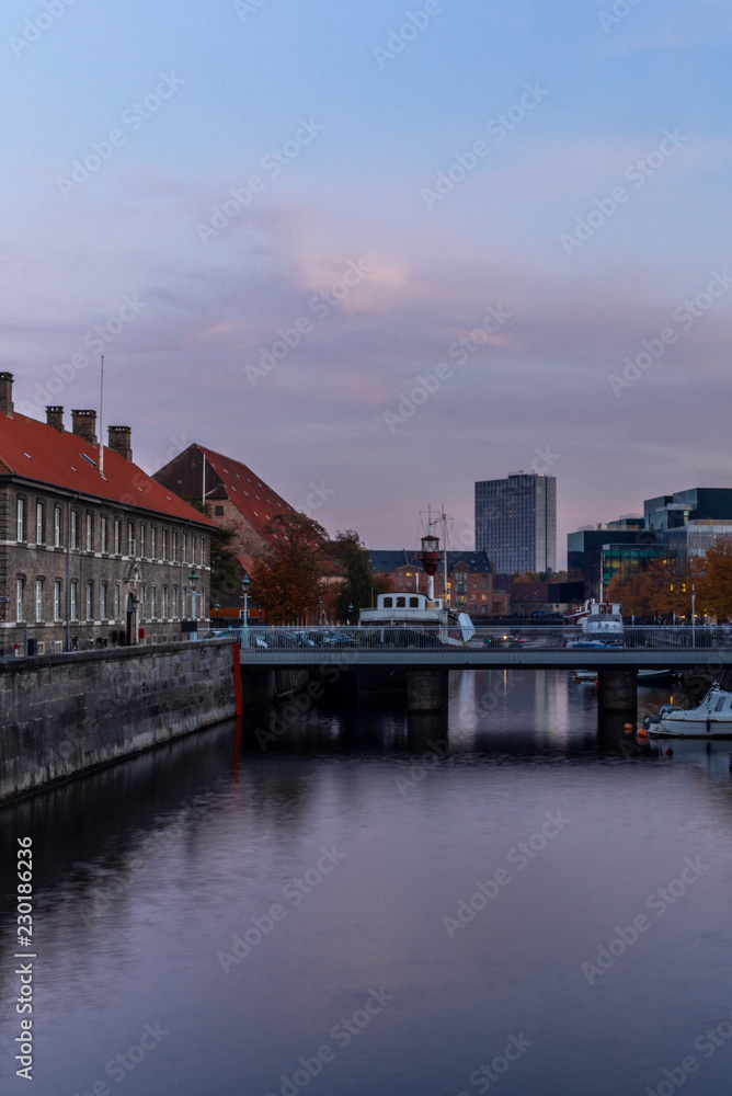 Sunset in Copenhagen on an old canal with boats and houses reflecting in the calm waters - 5