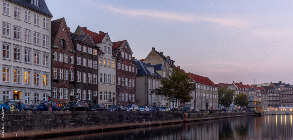 Sunset in Copenhagen on an old canal with boats and houses reflecting in the calm waters - 6