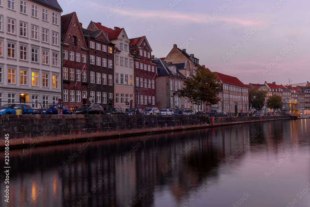 Sunset in Copenhagen on an old canal with boats and houses reflecting in the calm waters - 7
