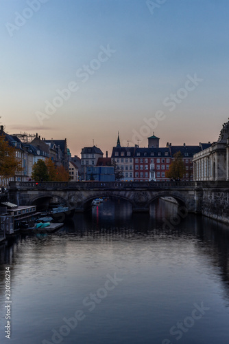 Sunset in Copenhagen on an old canal with boats and houses reflecting in the calm waters - 4