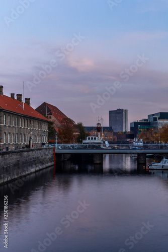 Sunset in Copenhagen on an old canal with boats and houses reflecting in the calm waters - 5