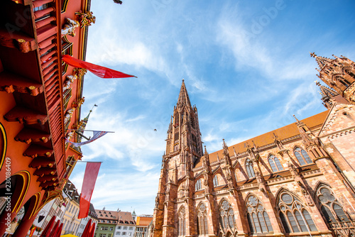 View from below on the main cathedral in the old town of Freiburg, Germany photo