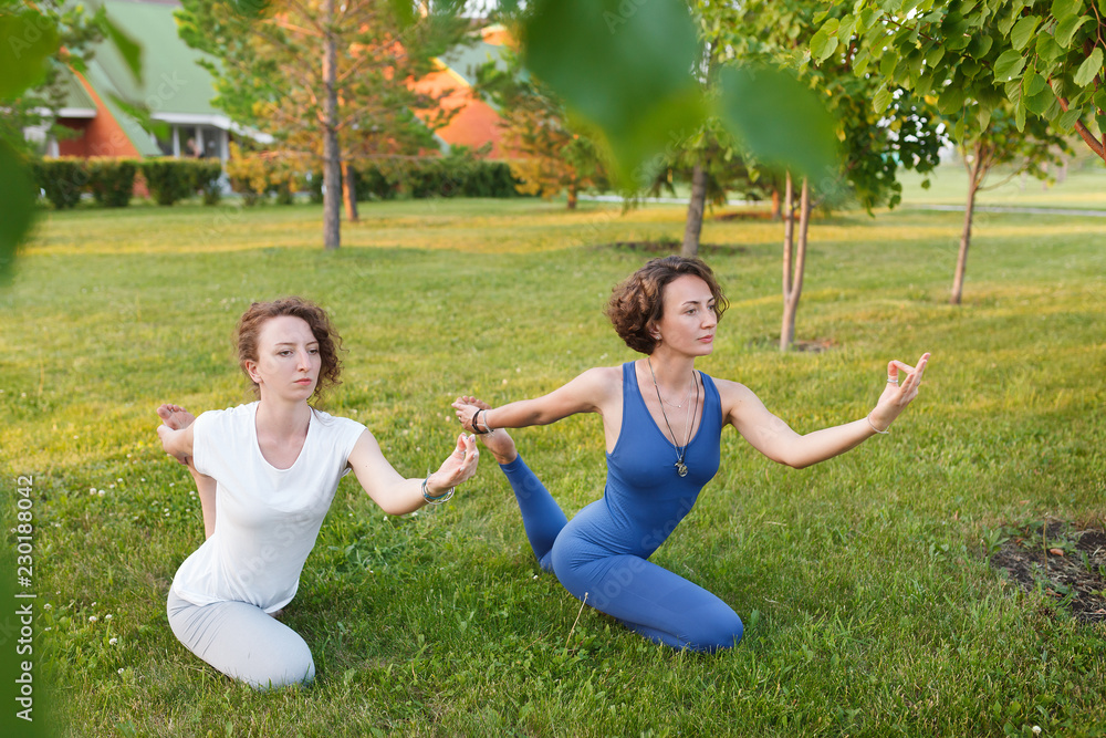 Beautiful girlfriend in gymnastic suits doing yoga Beautiful girlfriend in gymnastic suits doing yoga