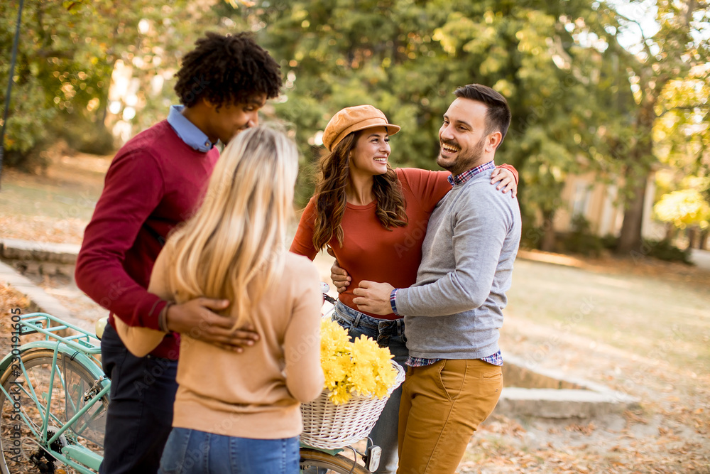 Multiracial young people walking in the autumn park Multiracial young people walking in the autumn park