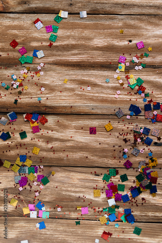 festive background from wooden boards and confetti