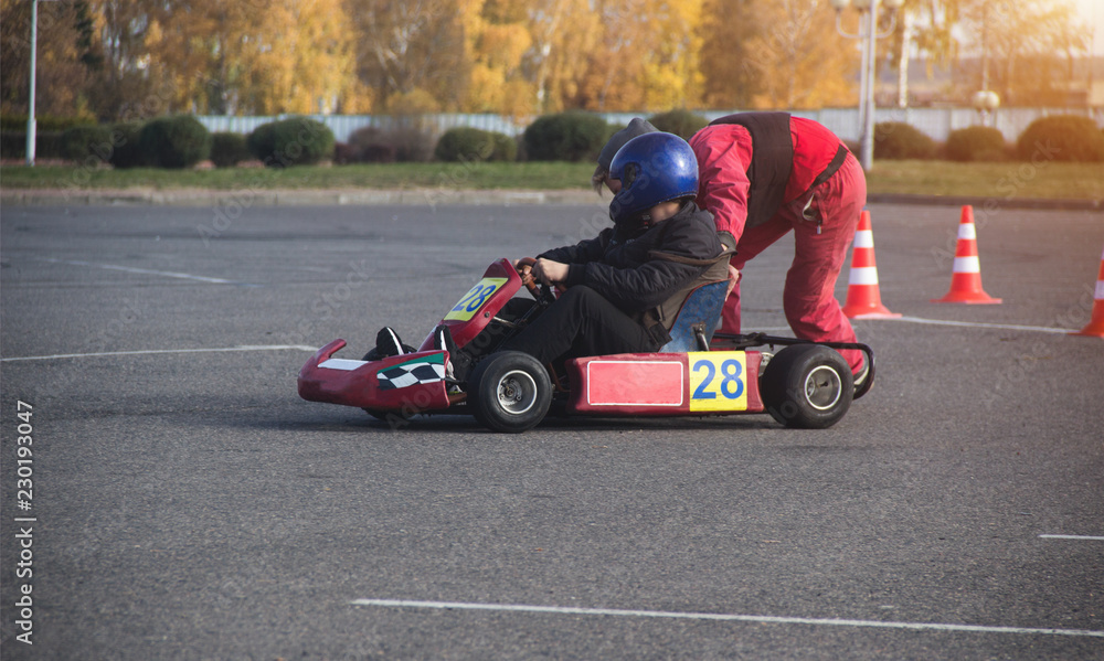 Karting competition, the participant pushes the young man in karting for karting, driver Karting competition, the participant pushes the young man in karting for karting, driver