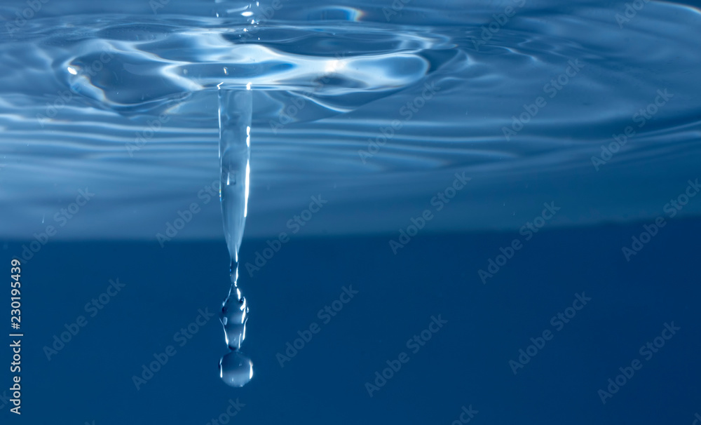 Drops of rain fall into the water, selective focus close-up Drops of rain fall into the water, selective focus close-up
