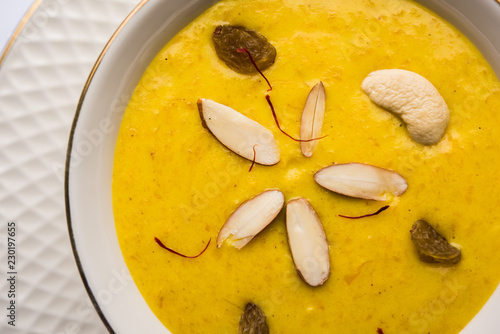 Kaddu or Pumpkin Kheer Or Bhoplyachi Kheer in Marathi and gummadikaya payasam in Telugu, Garnished with dry fruits. served in a bowl over moody background. Selective focus photo