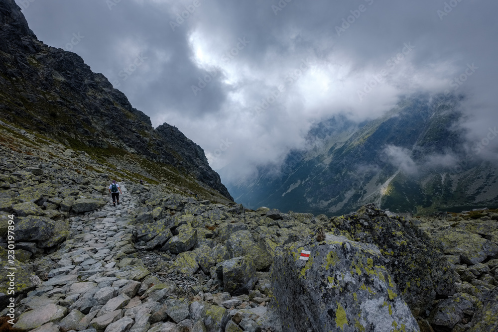 peak of Rysy mountain covered in mist. autumn ascent on hiking trails peak of Rysy mountain covered in mist. autumn ascent on hiking trails