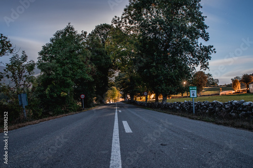 road in the mountains at night with a dark night sky © Alberto