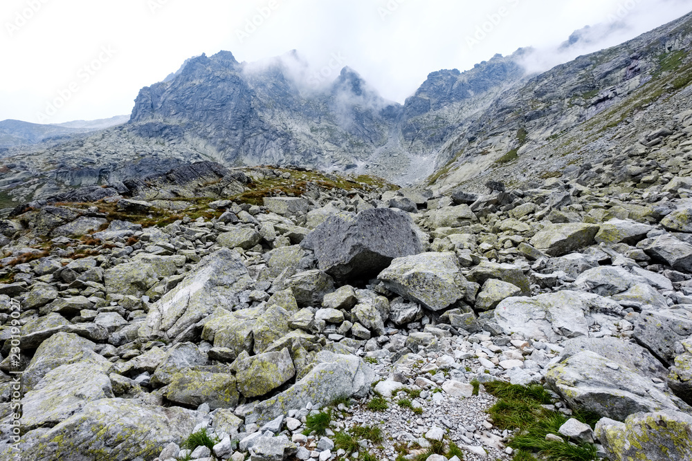 peak of Rysy mountain covered in mist. autumn ascent on hiking trails peak of Rysy mountain covered in mist. autumn ascent on hiking trails