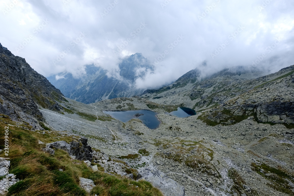 peak of Rysy mountain covered in mist. autumn ascent on hiking trails