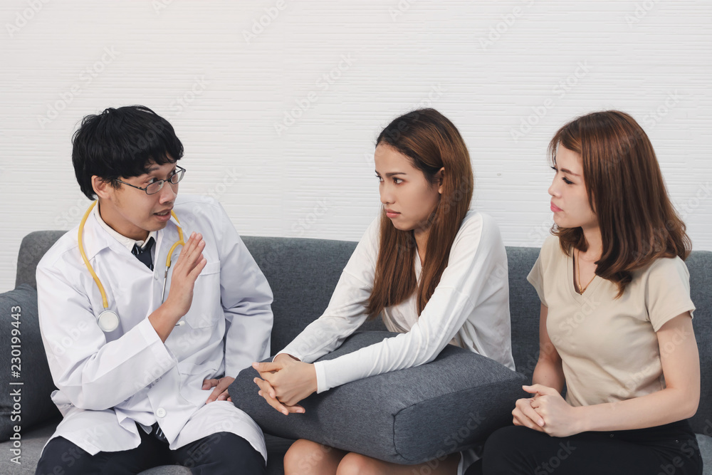 Young Asian male doctor consulting patient in hospital office. Health care and medical concept.