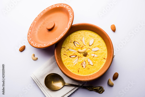 Kaddu or Pumpkin Kheer Or Bhoplyachi Kheer in Marathi and gummadikaya payasam in Telugu, Garnished with dry fruits. served in a bowl over moody background. Selective focus photo