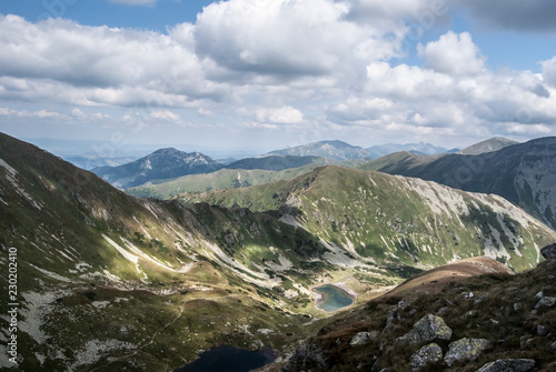 súectacular panorama of Western Tatras and High Tatras mountains on the background with many peska and lakes from hiking trail bellow Ostry Rohac peak in Slovakia photo