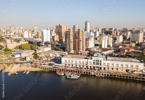 Panoramic view of skyscrapers skyline of Latin American capital of Asuncion city, Paraguay. Embankment of Paraguay river. Birds eye aerial drone photo. Ciudad de Asunción Paraguay.