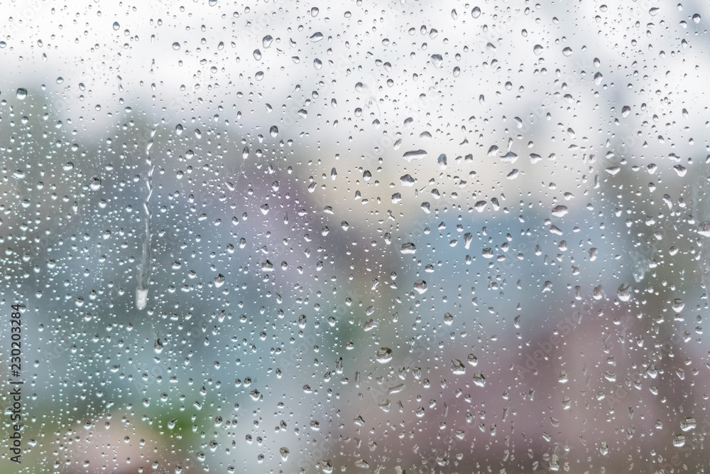 Rain drops on a window glass. Abstract background texture.