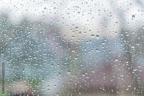 Rain drops on a window glass. Abstract background texture. Defocised image