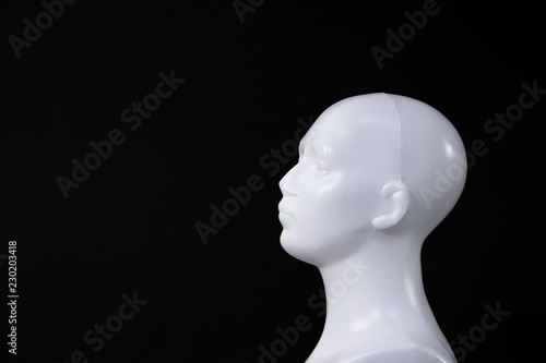 isolated white mannequin or doll human head on black background for health 