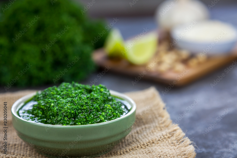Pesto from kale. Kale, cheese, lemon, pine nuts and garlic on the background Pesto from kale. Kale, cheese, lemon, pine nuts and garlic on the background