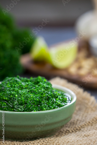 Pesto from kale. Kale, cheese, lemon, pine nuts and garlic on the background