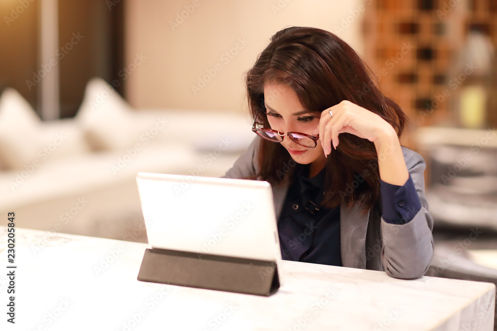 working and charming woman with glasses using tablet (work from home concept) working and charming woman with glasses using tablet (work from home concept)