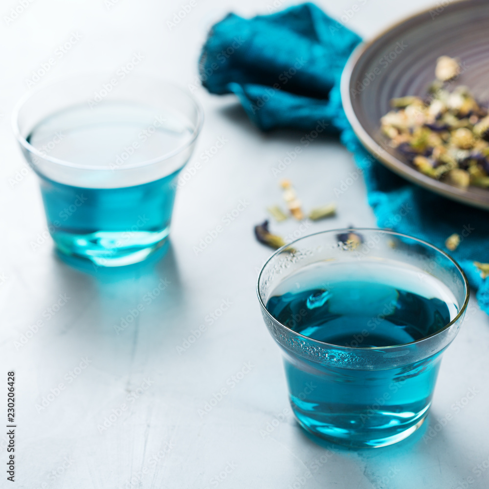 Blue butterfly pea flowers tea in a glass on table Blue butterfly pea flowers tea in a glass on table