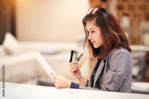 beautiful businesswoman shopping and online payment by using tablet and credit cards on hand