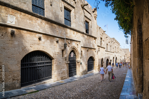 Couple walking down the street of knights  Ippoton  in City of Rhodes  Rhodes  Greece .